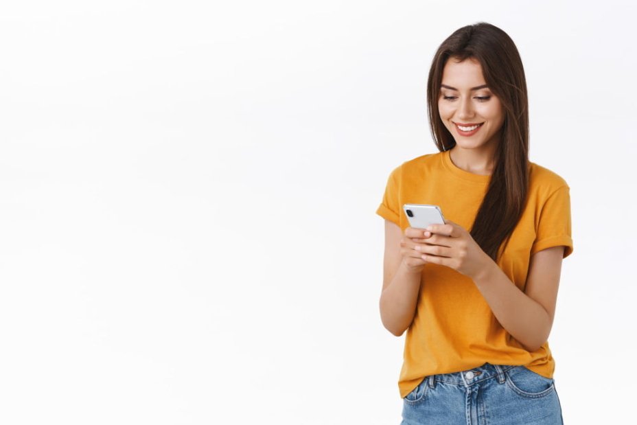Mulher sorrindo segurando um aparelho celular